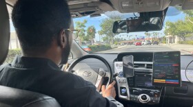 Jama Ali drives his Toyota Yaris cab on Nov. 12, 2025 in San Diego, Calif.