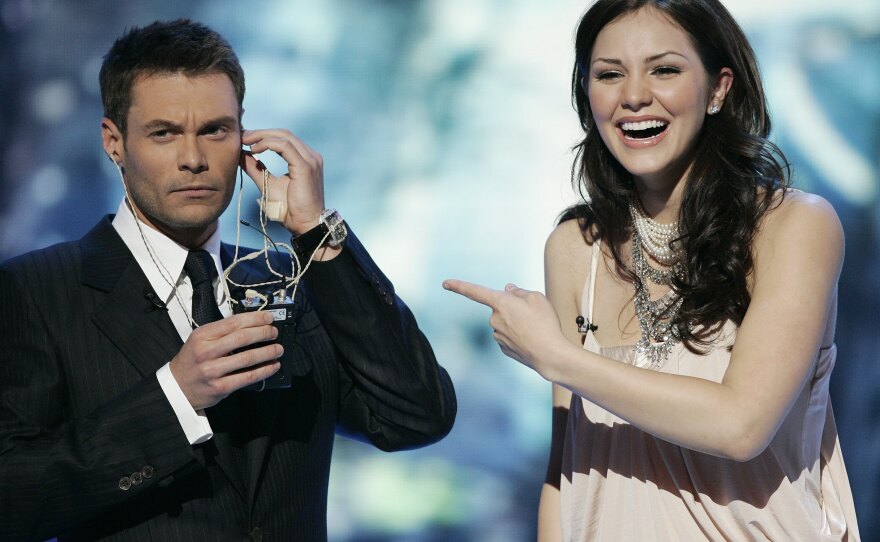 <em>American Idol</em> finalist Katharine McPhee and host Ryan Seacrest during the Season 5 final performances in 2006.