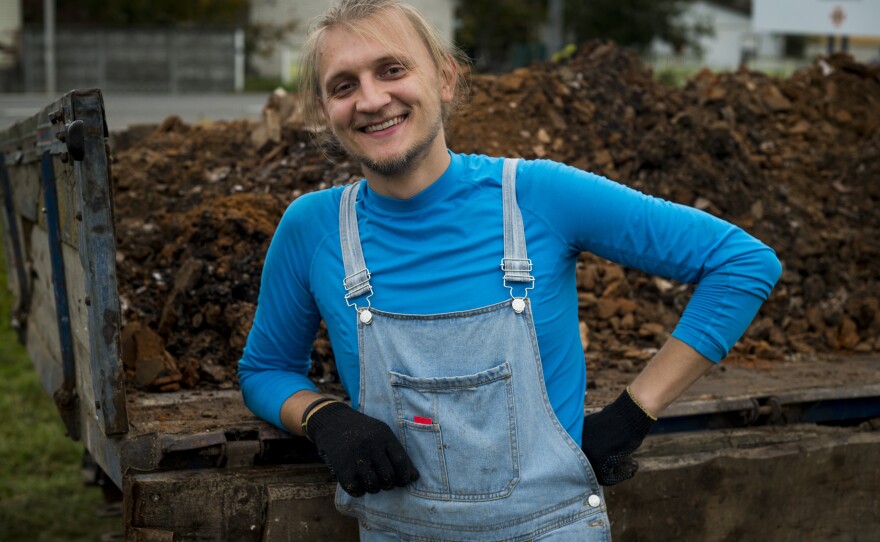 Roman Tarasiuk, 27, helps clean up the destroyed home of Hanna Yurchenko in Kolychivka on Oct. 1.