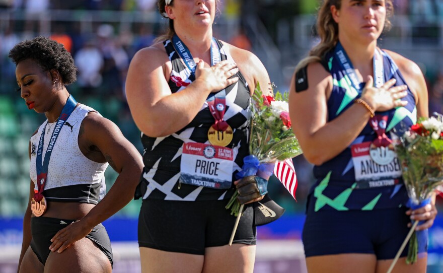 Gwendolyn Berry (left) turned away from the U.S. flag in protest on the podium after the Women's Hammer Throw final of the 2020 U.S. Olympic Track & Field Team Trials last month.