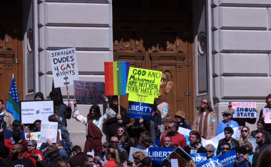 Some of the hundreds of people who gathered outside the Indiana Statehouse on Saturday, for a rally against legislation signed Thursday by Gov. Mike Pence.