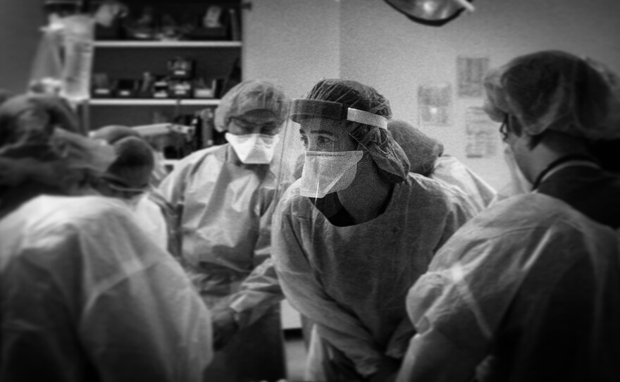 Dr. Molly Grassini watches the cardiac monitor during a pulse check, looking for signs of life in her patient.