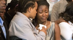 The daughter of Alfred Olango gets tearful while listening to her grandmother, Pamela Benge speak of her son, Alfred Olango, at a press conference in San Diego, Sept. 29, 2016.