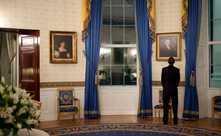 President Barack Obama looks at a portrait of President John Adams while waiting in the White House's Blue Room prior to a news conference in the East Room on Feb. 9, 2009.