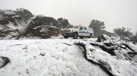 This Nov. 28, 2019 file photo provided by the Santa Barbara County Fire Department shows a Santa Barbara Fire Department truck along E. Camino Cielo as snow falls at the 3,500 foot level on the fire footprint in Santa Barbara, Calif. 