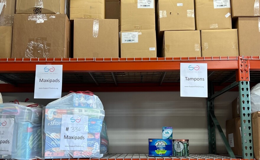 A shelf in a warehouse used by the nonprofit I Support The Girls is nearly empty of the tampon supply it keeps to distribute to people in need.