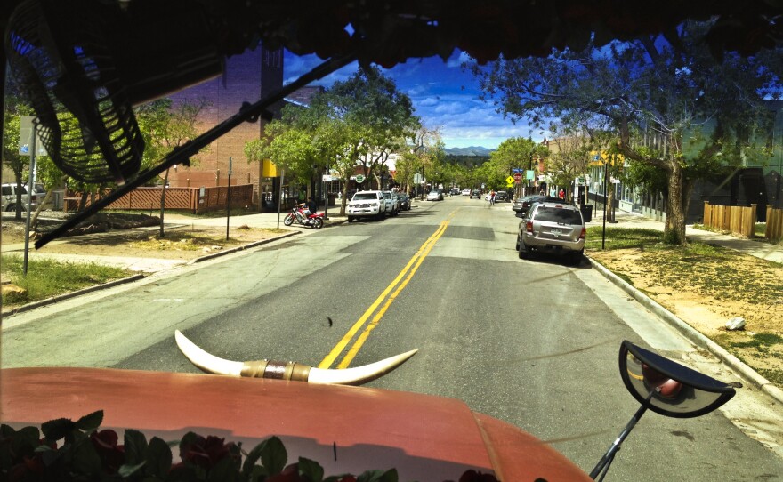 The Banjo Billy bus cruises along 13th Street on Boulder's University Hill. The brick building on the left is home to the historic Flatirons Theatre, which figures into one of Billy's more grisly tales.