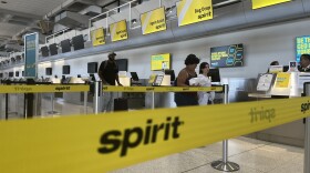 Travelers walk past the Spirit Airlines check-in counter at San Diego International Airport Terminal 1, Sept. 4, 2025.