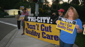 Tri-City Medical Center workers,  Jorge and Cindy Bravo, protest outside the hospital's fundraiser dinner held at Aviara Resort in Carlsbad, Nov. 7, 2015.

