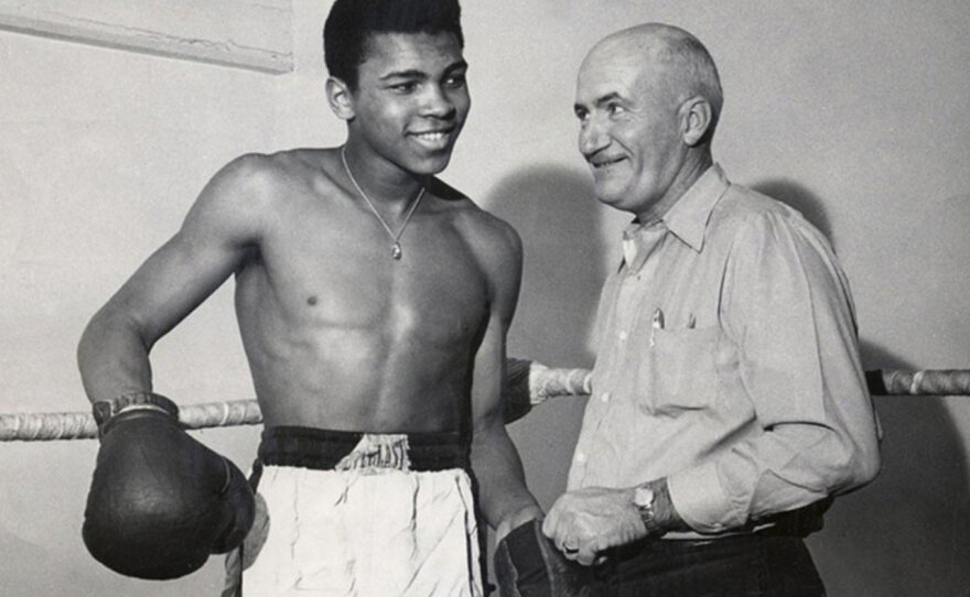 A young Muhammad Ali, then Cassius Clay, in 1960 with his trainer Joe Martin. Ali got his start on <em data-stringify-type="italic">Tomorrow's Champions</em>, a local television program in Louisville, Ky., that featured bouts between amateur boxers.