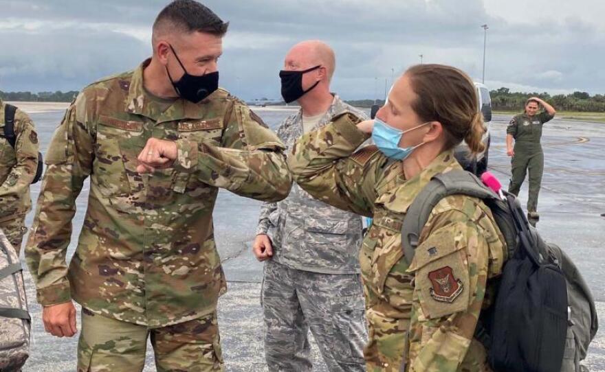 Sgt. Paul Tomlinson and Col. Jennifer Robyn Ratcliff greet each other with an elbow bump as she and her team returned to MacDill Air Force Base in Florida after a two-month deployment to New York to fight COVID-19 in this undated photo.