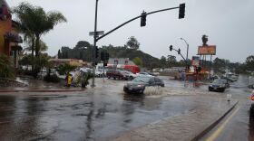 Cars drive through flooding at College and University avenues, Jan. 20, 2017.