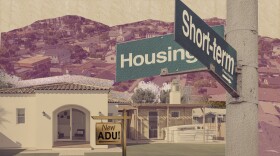 An artistic illustration depicts a residential neighborhood with houses and hills in the background. In the foreground, a sign on a post points in two directions. One sign points to "Housing" and the other, pointing in the opposite direction, points to "Short-term Rentals." A small wooden sign on a post in the front yard of one of the houses reads "New ADU!"