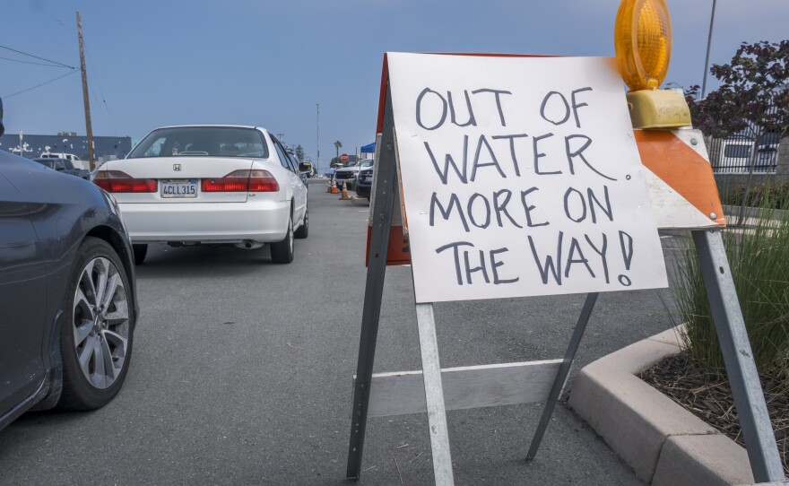 A sign outside a water distribution site in Imperial beach reads, "Out of water more on the way!" on Aug. 25, 2023. California American Water company was giving out drinking water to customers in the South Bay impacted by a boil water advisory issued due to possible E. coli contamination. 