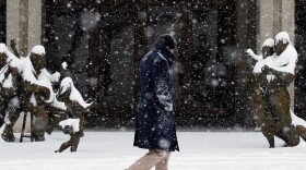 A man walks in downtown Asheville, N.C., after a snowfall of over 6 inches  hit the Blue Ridge Mountains on Monday.