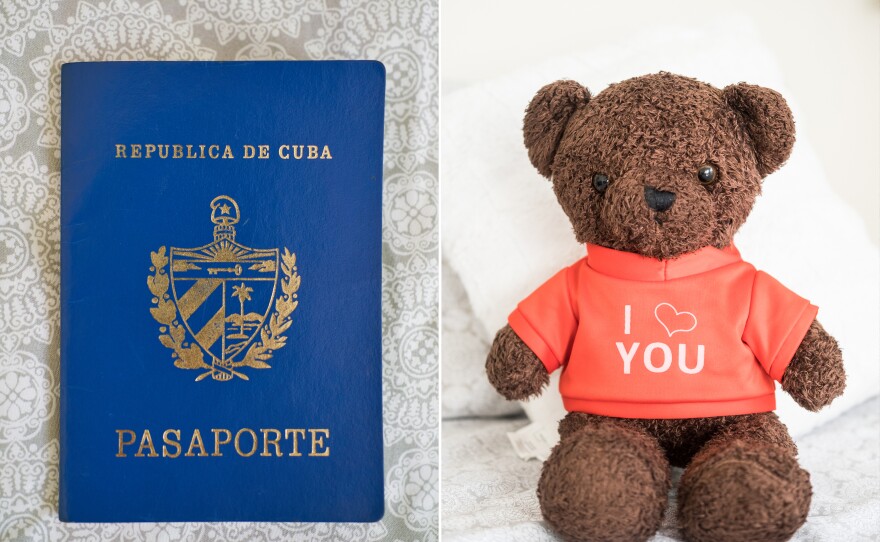 Yossell's Cuban passport is resting on the couch in his home in Tampa, Florida. A teddy bear wearing a shirt that reads "I love you" adorns Yossell's bed in Tampa — migration also means being distant from your loved ones that you left behind.