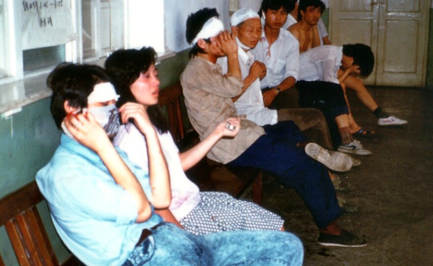 Those injured in the clashes wait to receive treatment. The prevalence of head wounds is indicative of the police strategy of beating protesters around the head. The injured begged the Western photographer to "tell the world!"