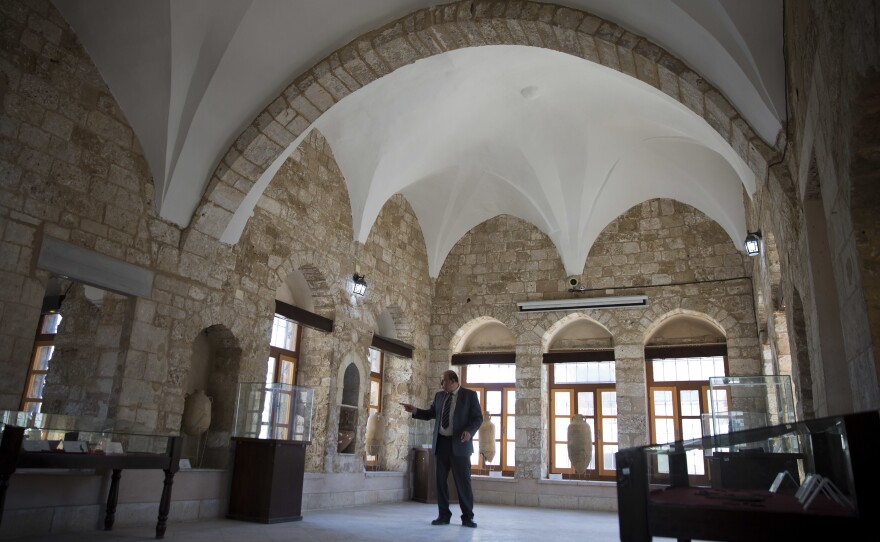 Hassouna stands inside Pasha's Palace in Gaza City.
