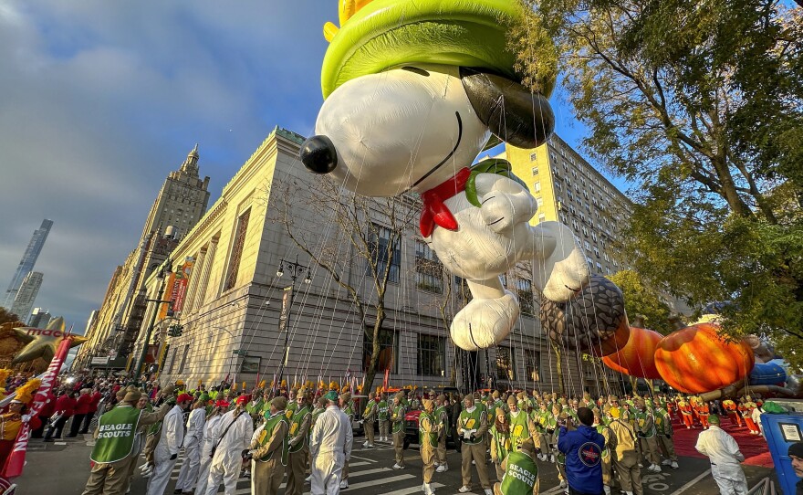 A Beagle Scout Snoopy balloon floats above Manhattan during the Macy's Thanksgiving Day Parade in November.