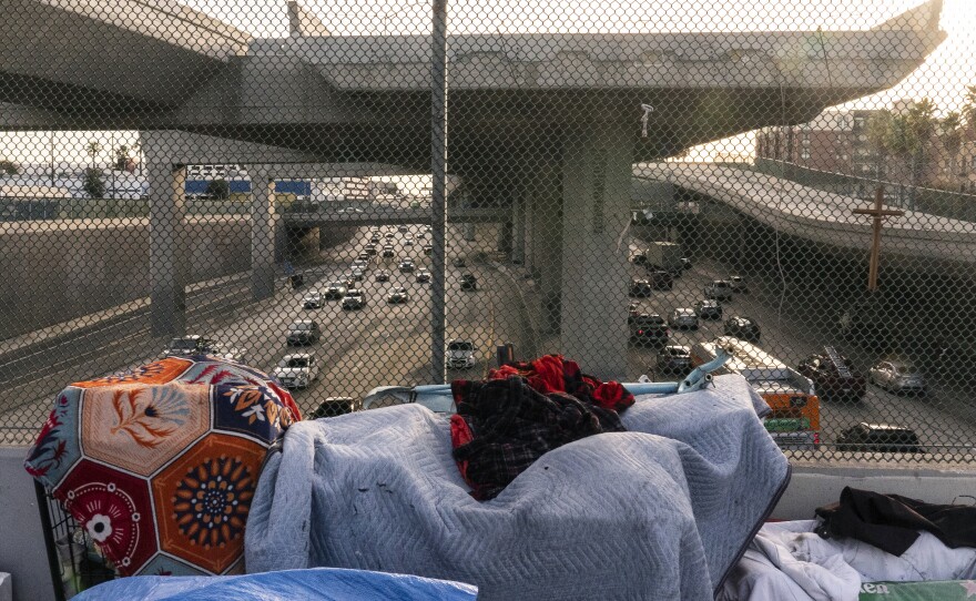 A homeless encampment is seen on a bridge over the CA-110 freeway, Wednesday, Dec. 15, 2021, in Los Angeles. 