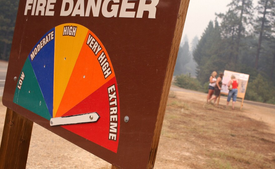 A sign displays current fire danger as extreme in Southern California.
