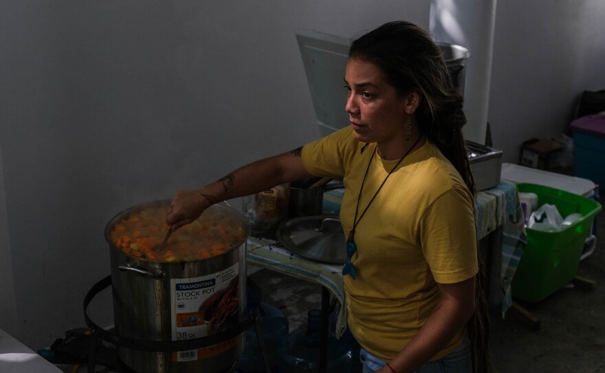 Loirad Ortiz Cedeño cooks during Huerto Callejón Trujillo's "sancocho comunitario" event Saturday in the community of Ponce Playa, Puerto Rico.