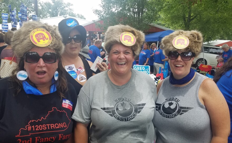 The August heat at a political event did not deter (from left) Laura Hartke, Christina Trosper and Katie Hancock from wearing their Russian-styled fur hat with buttons saying: "Say Nyet To Moscow Mitch."