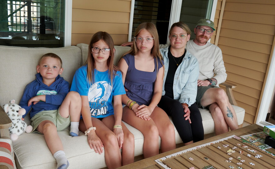 Jack, 4, Eden, 11, and Piper, 12, sit with their parents Amber and Neil Petersen.