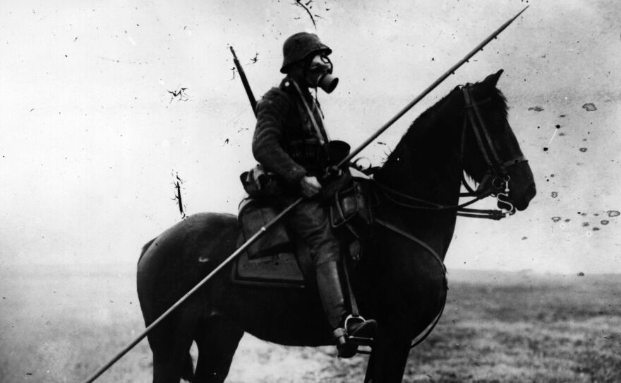 World War I was when the old world became the new. Here, a German cavalryman wears a gas mask and carries a long spear or pole, from two different ages of war.