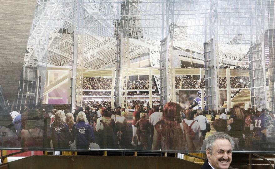 A rendering of the new Minnesota Vikings stadium hangs behind team owner Zygi Wilf at groundbreaking ceremonies for the new stadium on Dec. 3, 2013, in Minneapolis.