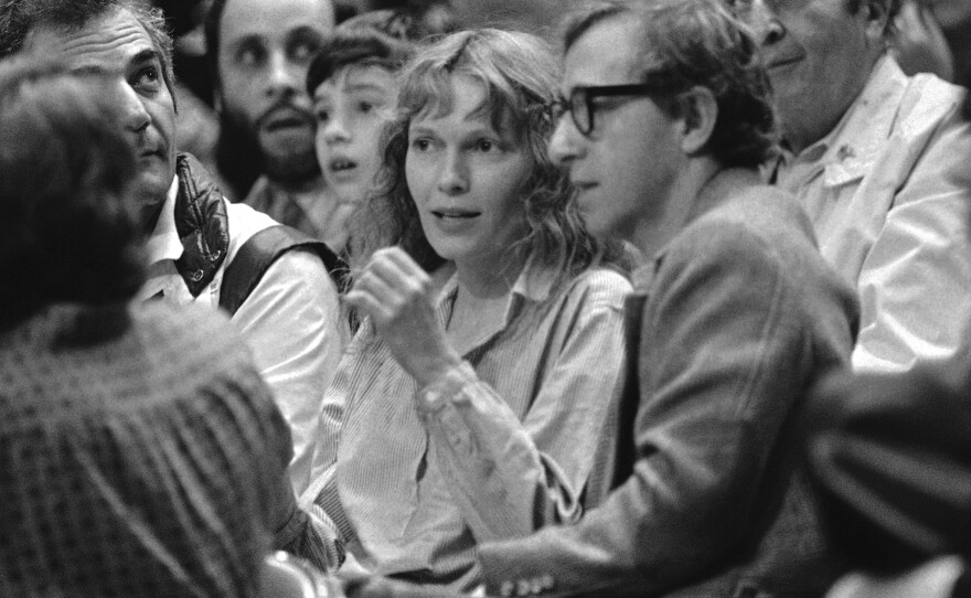 Mia Farrow and Woody Allen watch a basketball game in 1983. Dylan Farrow's statement alleging that Allen abused her was published online by a