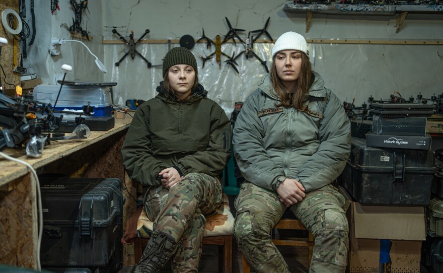 Yevhenia "Furia" (left), 19, a reconnaissance drone pilot, and Dasha "Galactica," 23, a first-person view drone pilot — both members of Ukraine's Khartiia 13th National Guard Brigade — sit in a drone workshop on Feb. 1.