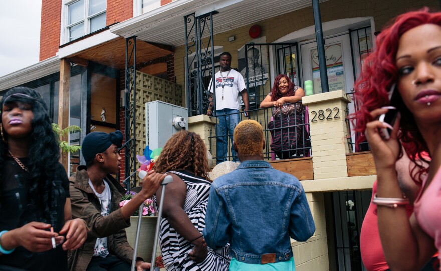 Ruby Corado, top center, sits on the porch of Casa Ruby, a drop-in and service center for transgender people in Washington, D.C., while many of her clients, friends and employees hang out in front.