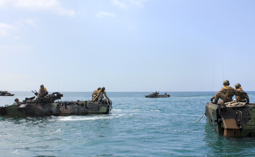 Troops at sea do a towing exercise, where one vehicle is "in distress" and the other has to tow it using ropes.