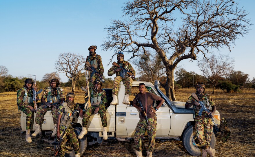 Zakouma's Mamba Team 1 anti-poaching unit includes driver Issa Adoum (brown shirt). After Sudanese poachers killed his ranger father, Adoum refused diya, a traditional community payment. "Diya is for accidents," he says.