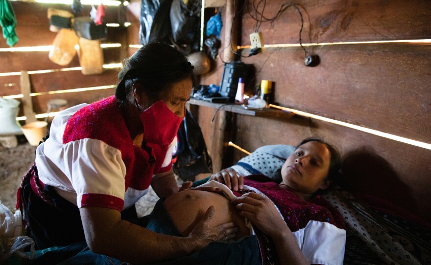 Midwife Petrona Hernández Díaz performs a pandemic prenatal checkup on Ana Laura Gómez Hernández.