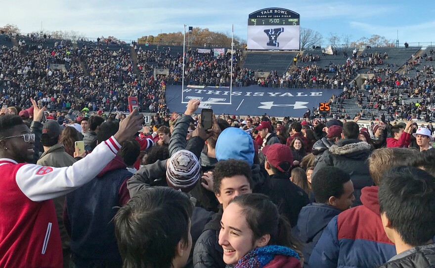 Demonstrators stage a protest on the field at the Yale Bowl disrupting the start of the second half of an NCAA college football game between Harvard and Yale, Saturday in in New Haven, Conn.