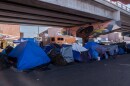 Tents from a camp filled with migrants are set up under a highway bridge near the El Chaparral border crossing in Tijuana, November 17, 2021.