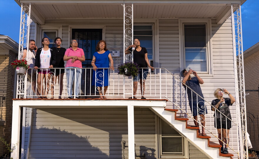 The family watches Fourth of July fireworks from in front of their house in 2022.