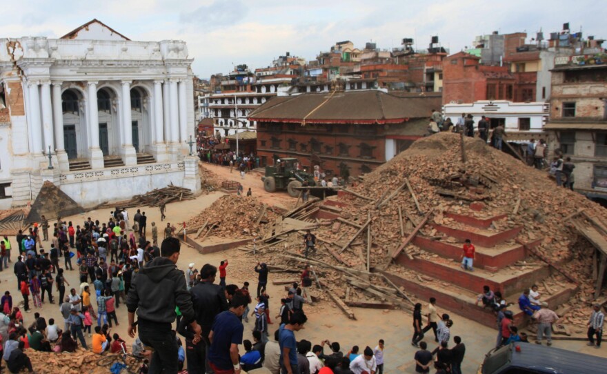 (Top) Nepalese devotees participate in a procession of chariots of god and goddess Ganesh, Kumari and Bhairav during the last day of Indrajatra festival at Durbar Square in Kathmandu, Nepal on Sept. 22, 2013. (Bottom) The ruins on the Durbar Square after an earthquake in Kathmandu on Saturday.