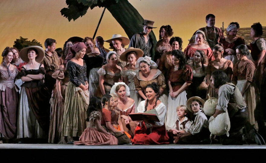 Anna Netrebko (center) as Adina in in Donizetti’s “L’Elisir d’Amore."