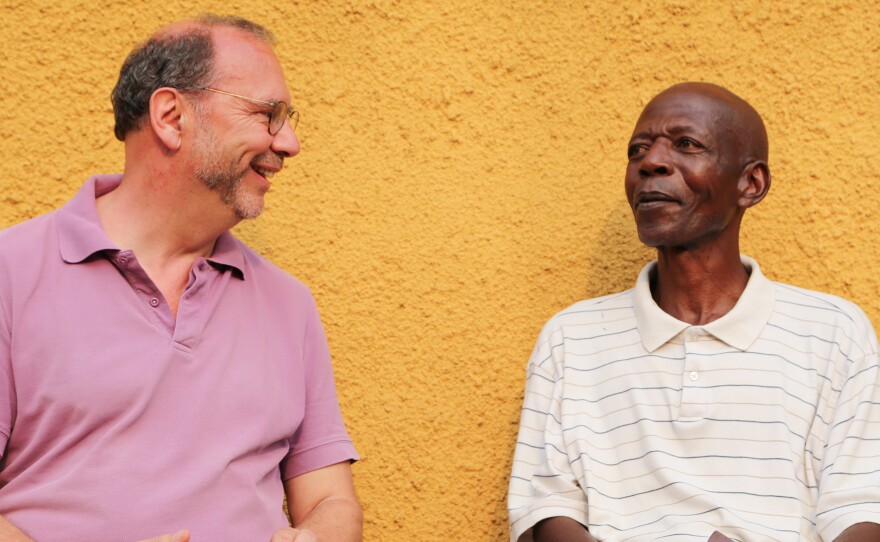 Dr. Peter Piot (right) meets with Sukato Mandzomba, a nurse who contracted Ebola during the 1976 outbreak. Mandzomba now runs a makeshift hospital lab in Yambuku.