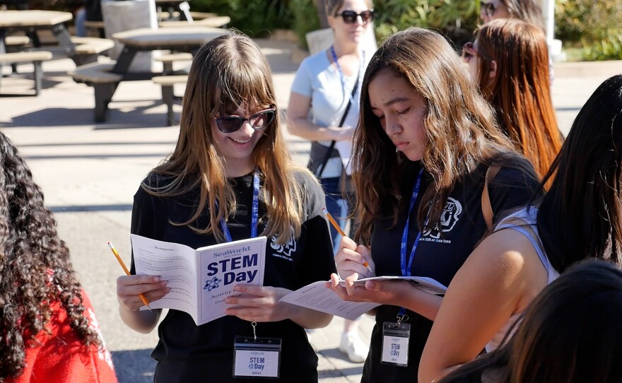 Jorie Northup (L) and Sofia Dickman (R) are shown looking at their special STEM booklets at SeaWorld on November 14, 2024.