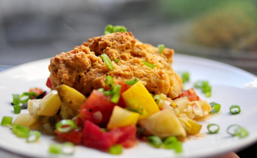 The savory summer cobbler from the Cheap and Good cookbook features seasonal vegetables under a peppery biscuit crust.