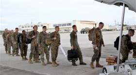 Marines board a KC-130J Hercules aircraft Nov. 10, 2013, at Marine Corps Air Station Futenma, Okinawa, Japan, moments before departing for a humanitarian assistance and disaster relief mission to the Philippines following Typhoon Haiyan.