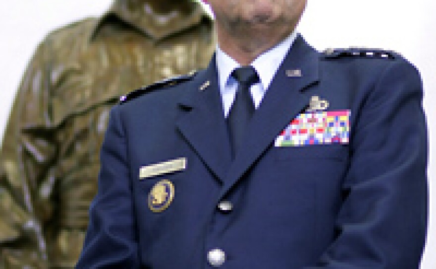 Central Intelligence Agency Director Gen. Michael Hayden stands in front of a statue of William Donovan, head of the OSS, the CIA's predecessor, during a swearing-in ceremony in Langley, Va.
