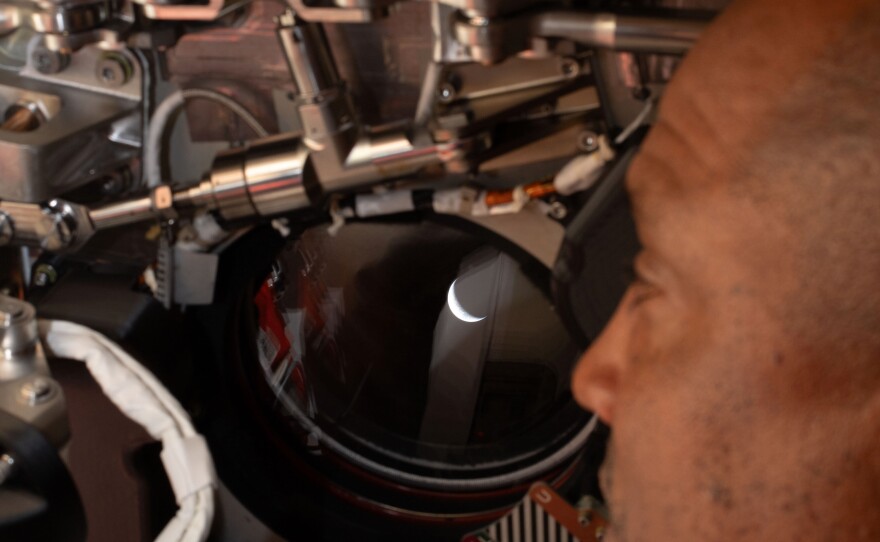 April 6: Artemis II pilot and NASA astronaut Victor Glover peers out one of the Orion spacecraft's windows looking back at Earth ahead of the crew's lunar flyby.