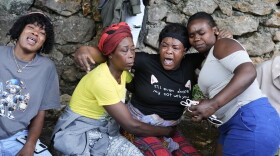 Women cry at the site where their relatives were killed in a gang attack in the Kenscoff neighborhood of Port-au-Prince, Haiti, Monday, Aug. 24, 2026.