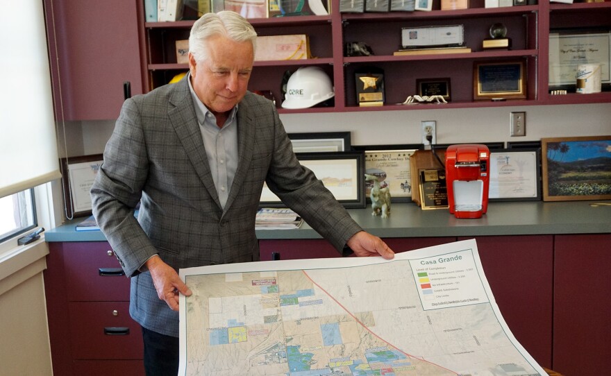 Casa Grande Mayor Craig McFarland holds a map showing land with and without a water supply. "Casa Grande will continue to grow," he says. "We have to be frugal with the water we have."