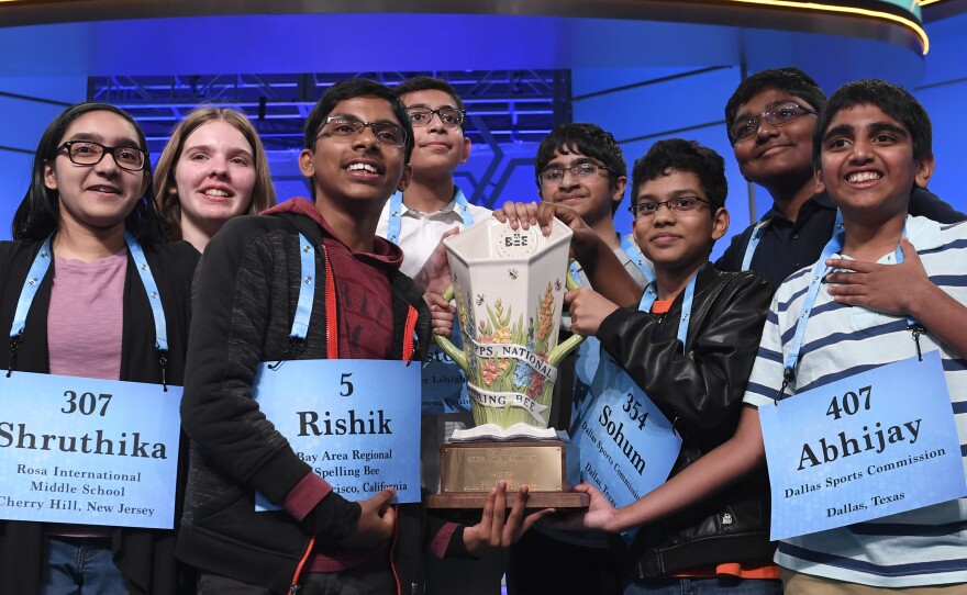 Co-champions of the 2019 Scripps National Spelling Bee (from left) Shruthika Padhy, Erin Howard, Rishik Gandhasri, Christopher Serrao, Saketh Sundar, Sohum Sukhatankar, Rohan Raja and Abhijay Kodali hold the trophy in Oxon Hill, Md., on Friday.